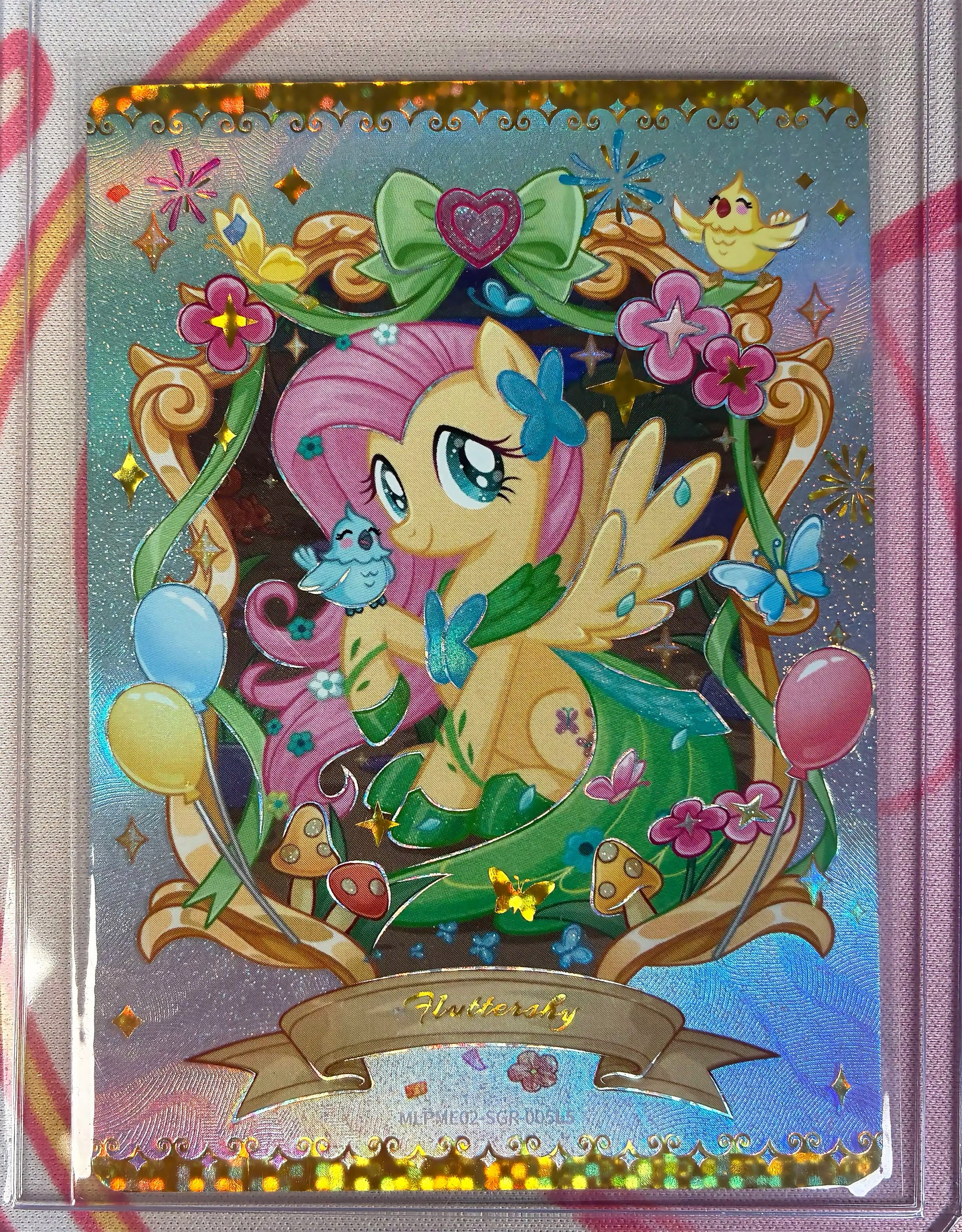 Fluttershy collectible card, My Little Pony MLPME02-SGR-005, holographic full-art with songbirds